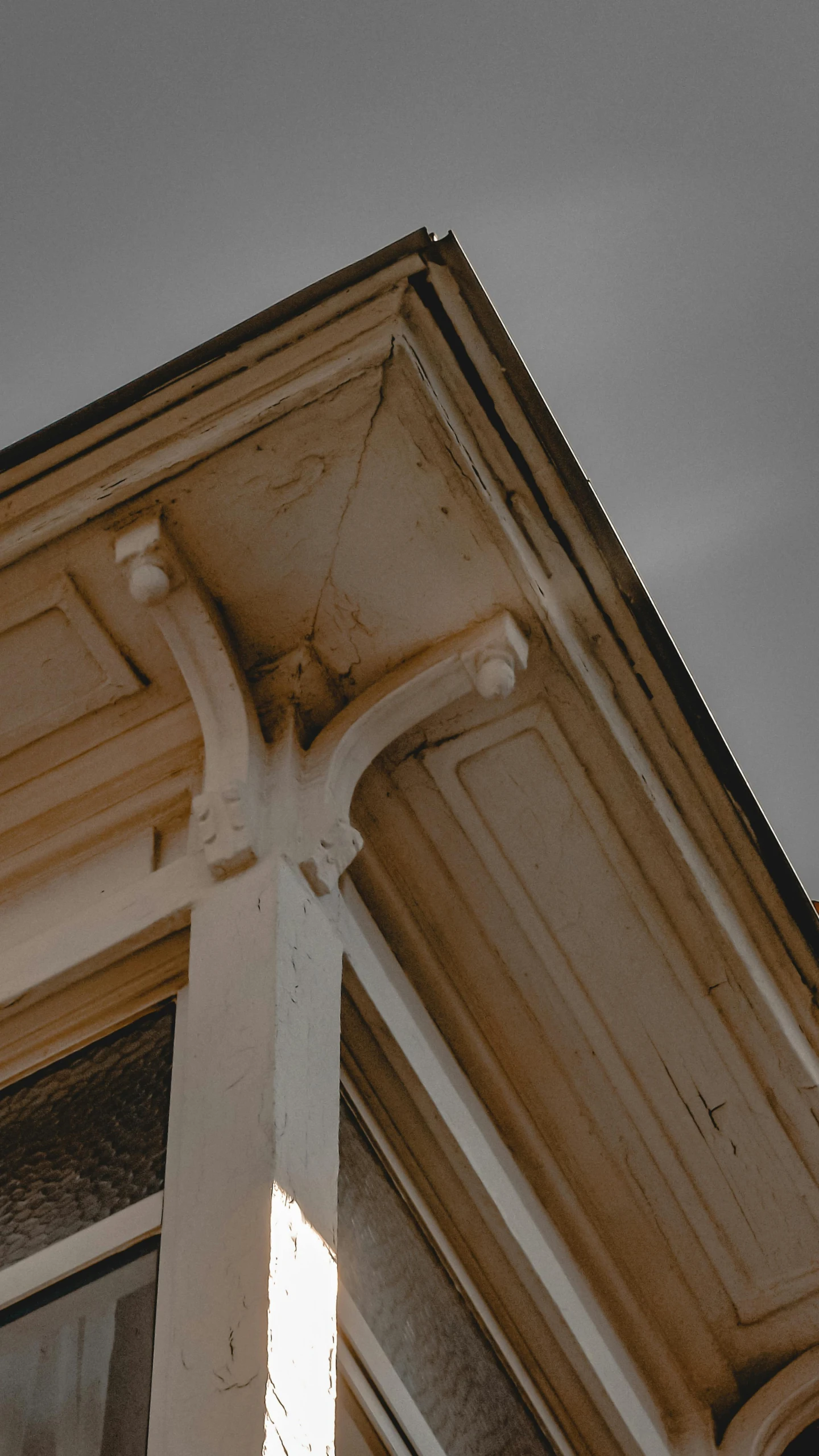 a light brown building with an owl statue in it's corner