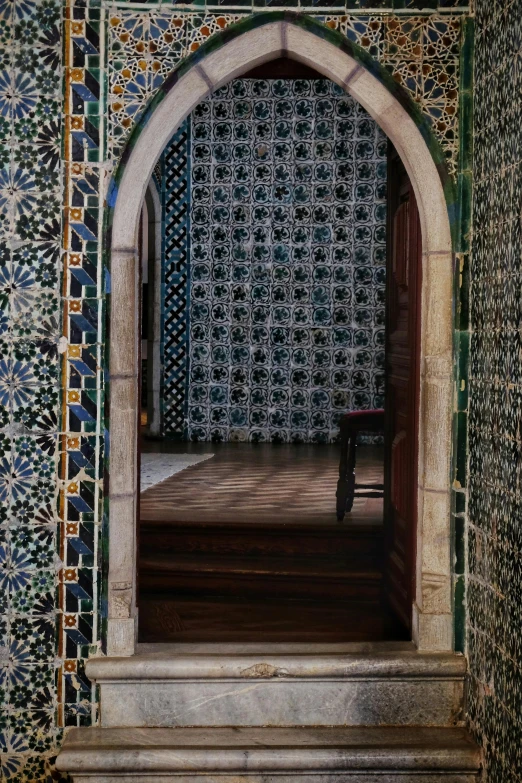 the archway into a hallway with intricate wall tiles