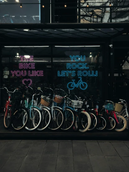 many bikes are parked in the bicycle rack outside of the store