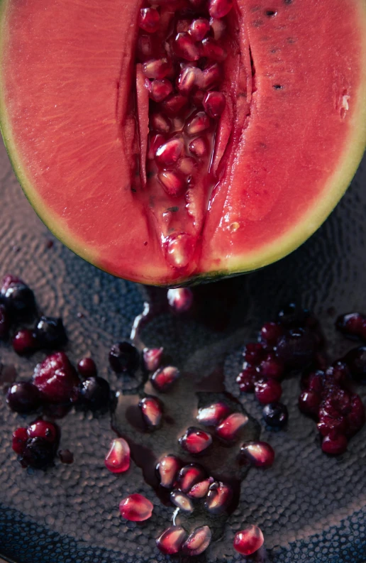 half a watermelon cut in half and some berries on top