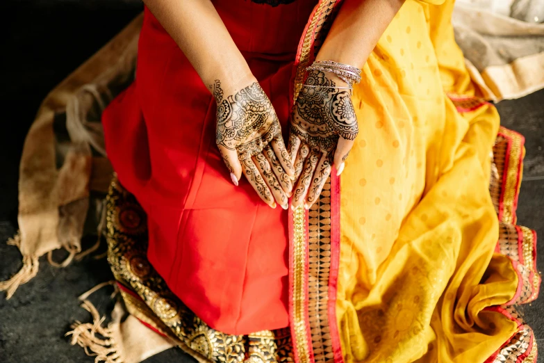 a woman sitting down with her hands resting on her hands