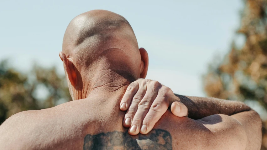 man getting back massage while in the day sun