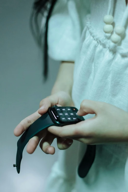 an asian girl holding a cellphone in her hands