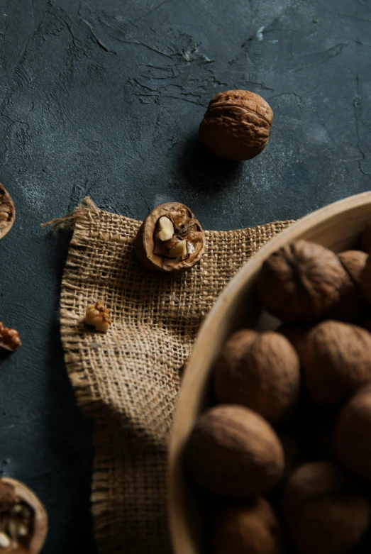 nuts scattered around a brown burlock on a cloth