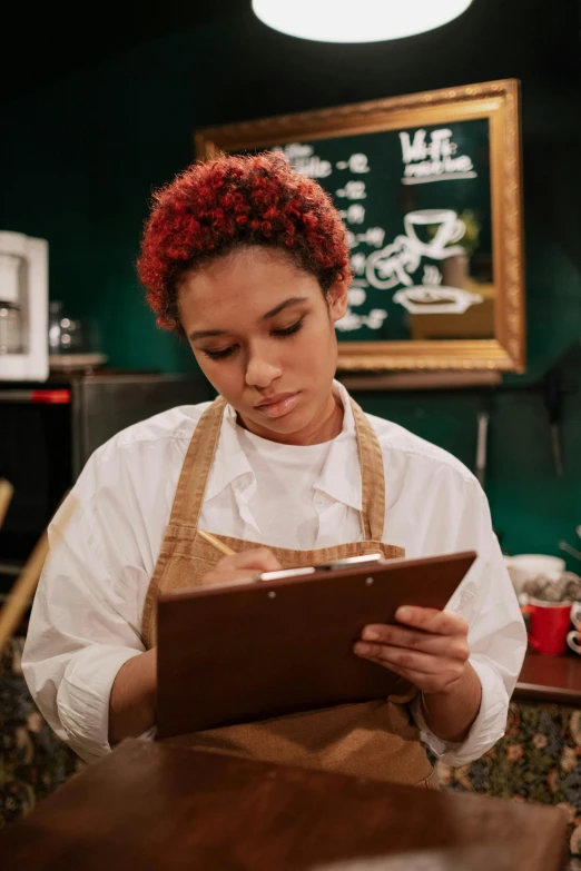 a person with red hair standing in a restaurant