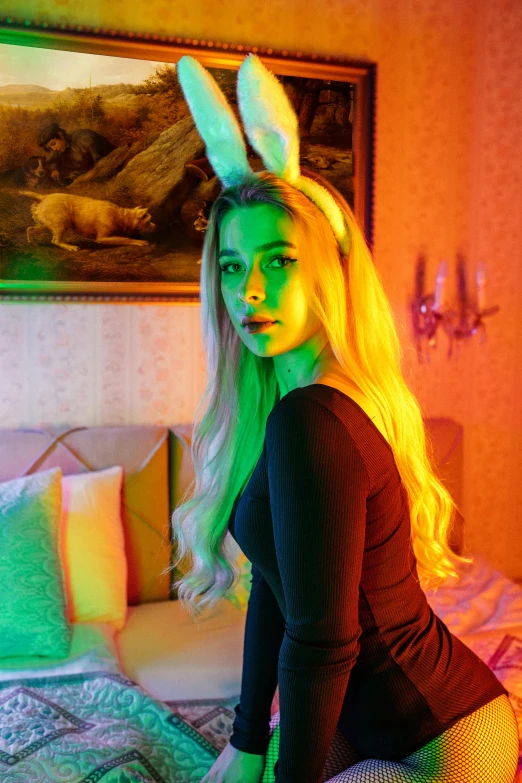 a girl sitting on a bed wearing bunny ears
