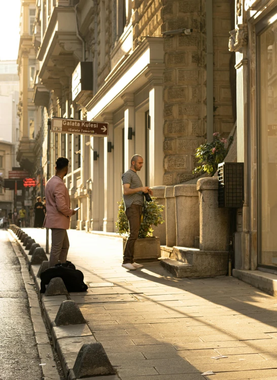 two men with their dogs waiting outside the entrance