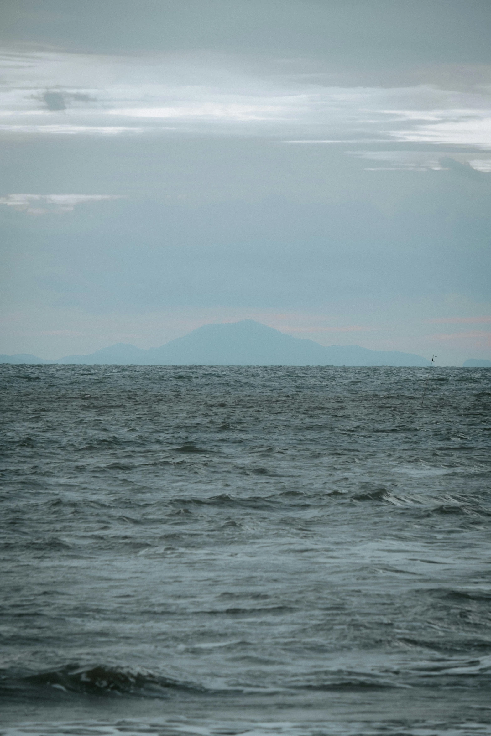 there is an ocean with two boats in the distance