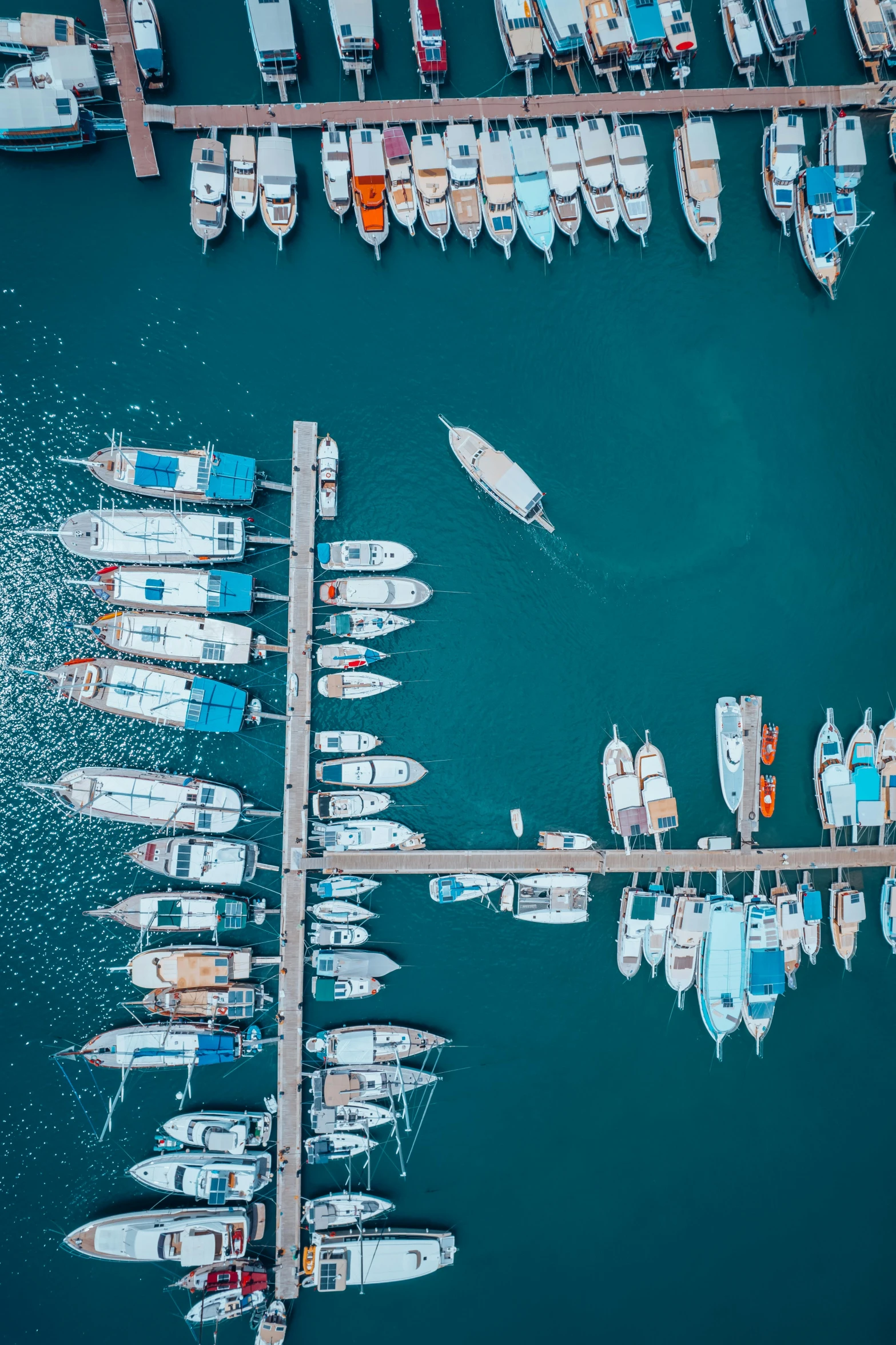 many boats in the water and surrounded by a pier