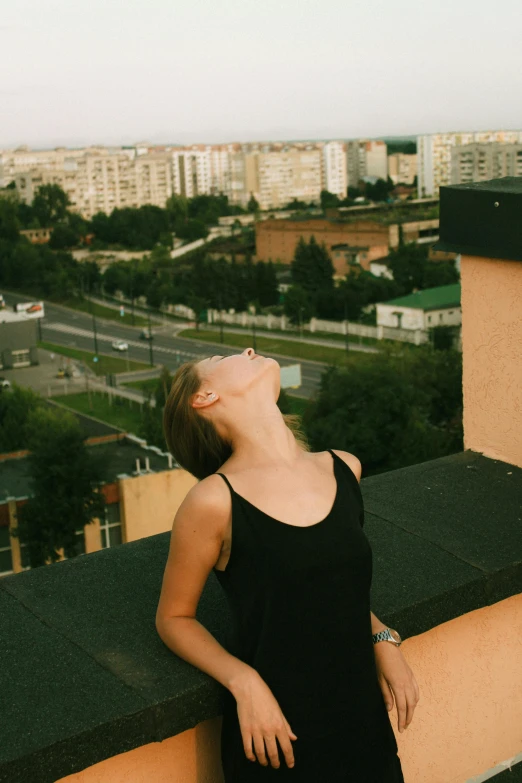 a beautiful young lady leaning on a wall