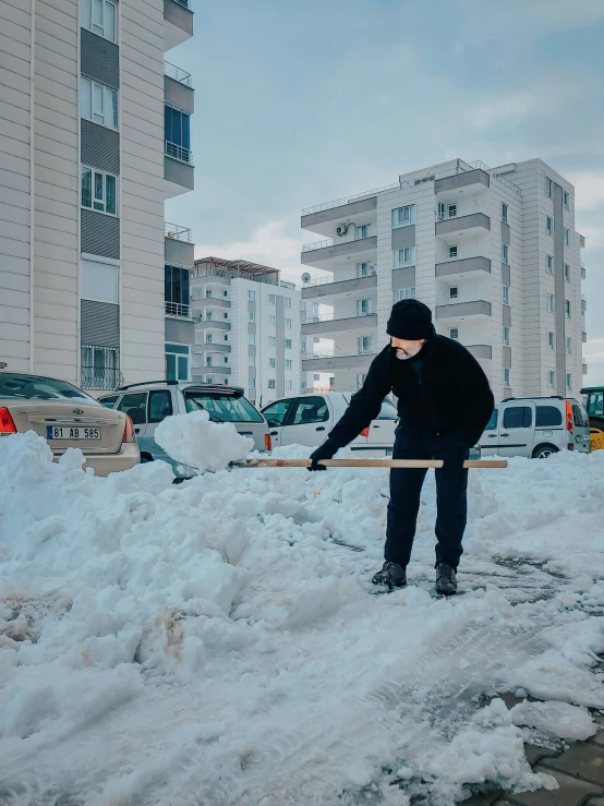 a man holding an ice stick in the snow