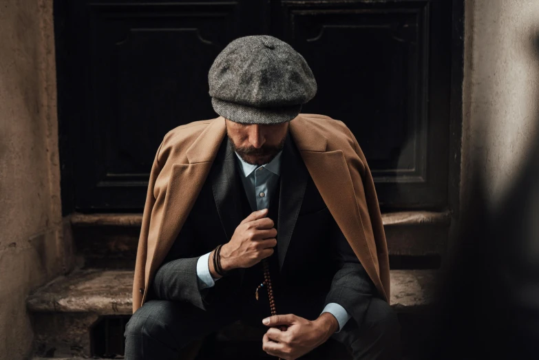 the man is sitting on the step with his jacket open