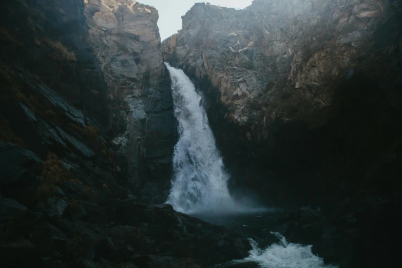 a large waterfall that is surrounded by rocks