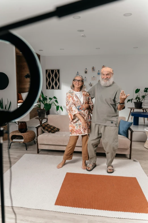 an older couple standing in the middle of a living room