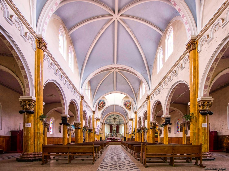 the inside of an ornate church with stone floors