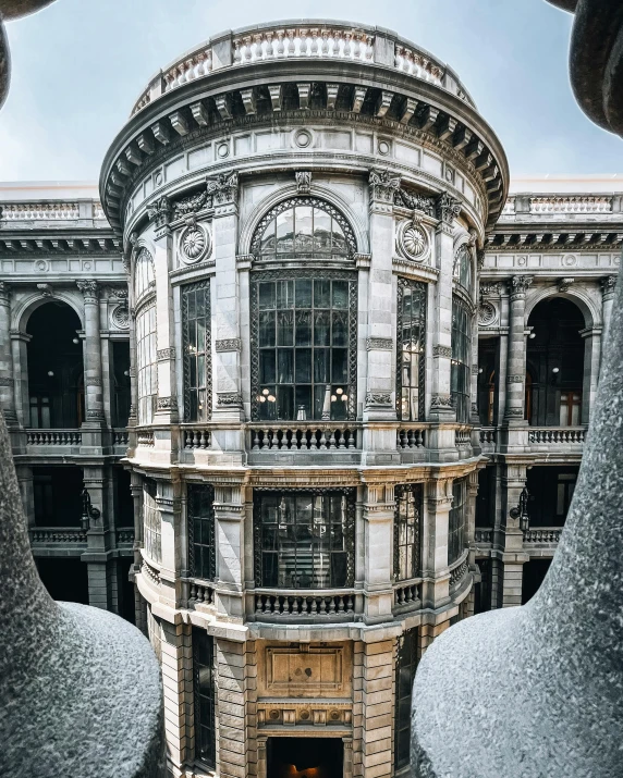 an intricate building is seen through a hole in the wall