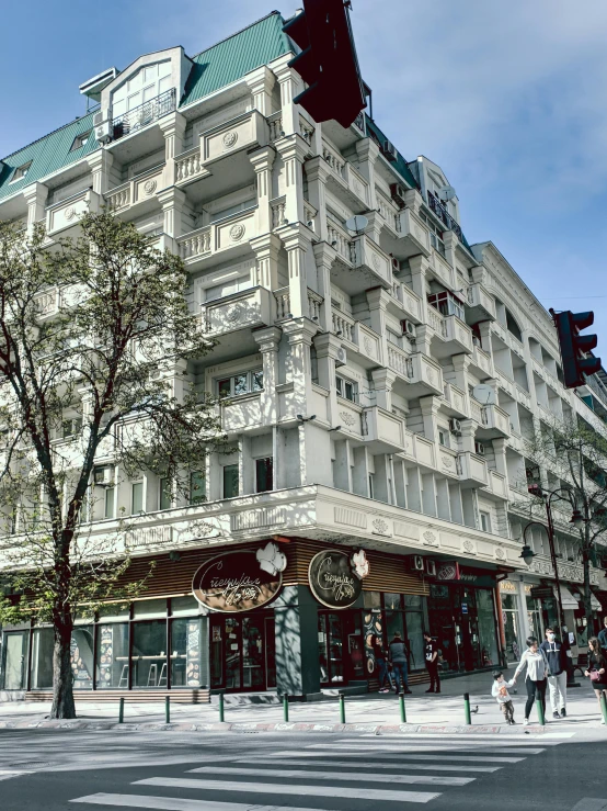 a building on a city street corner has green roof