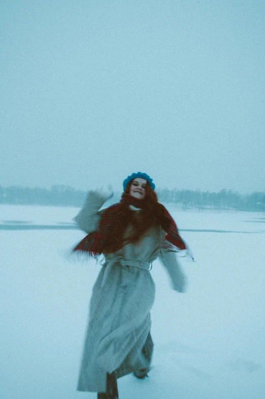 a person in the snow, holding soing up