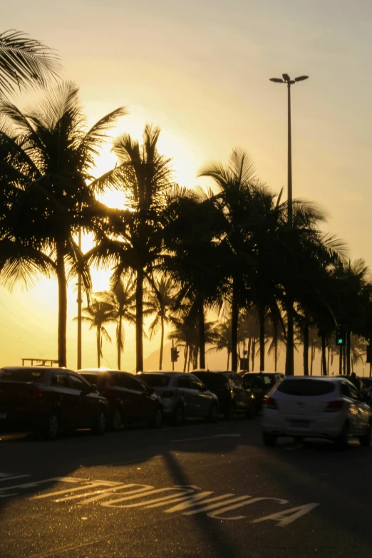 many cars that are parked on the side of a road