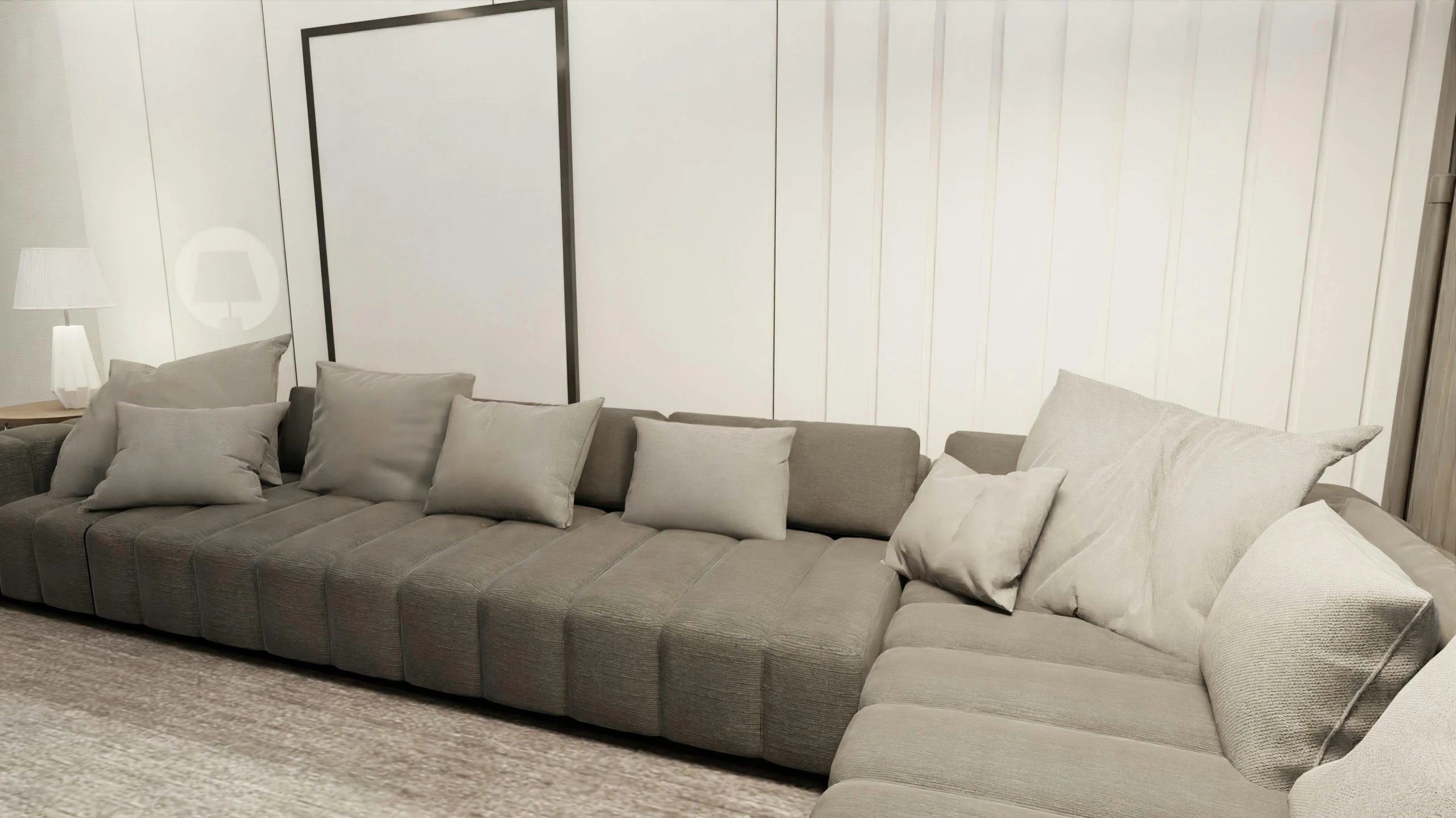 large grey sectional sofa in front of a white wall