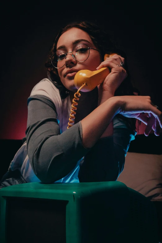 a person is talking on the telephone at night