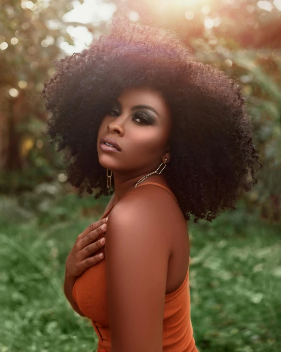 a black woman standing with her hair blowing in the wind