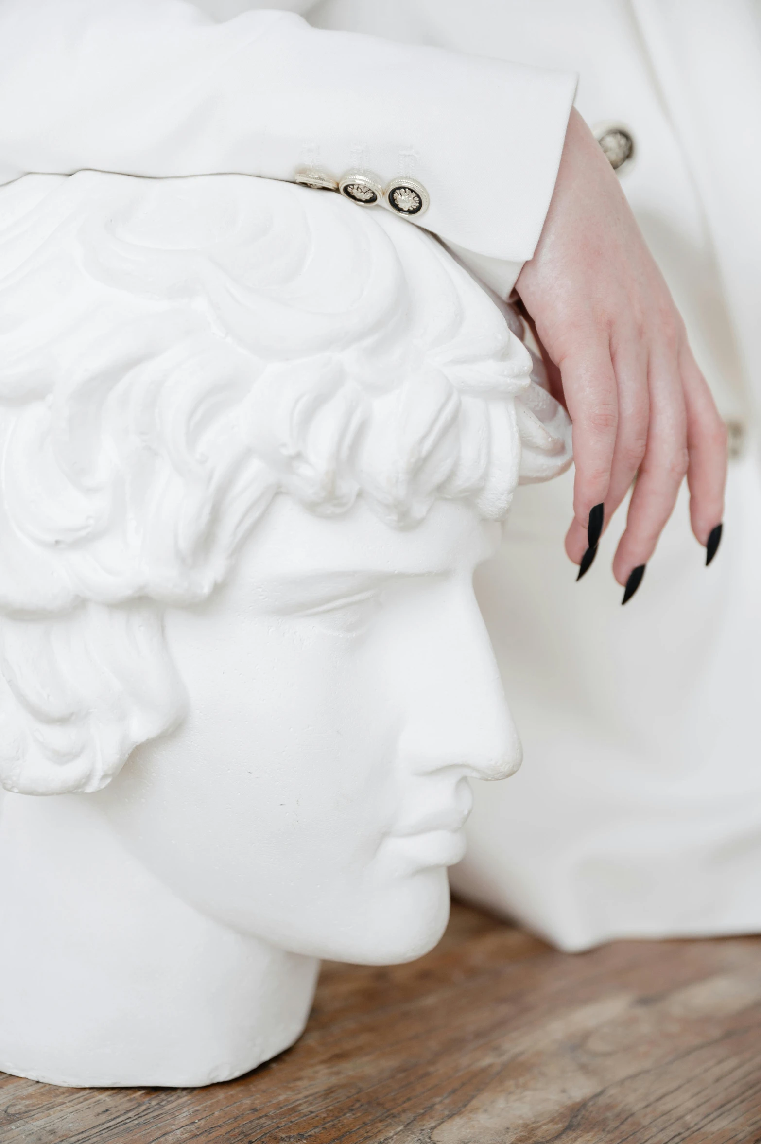 a manicured nail polish sits on top of a statue