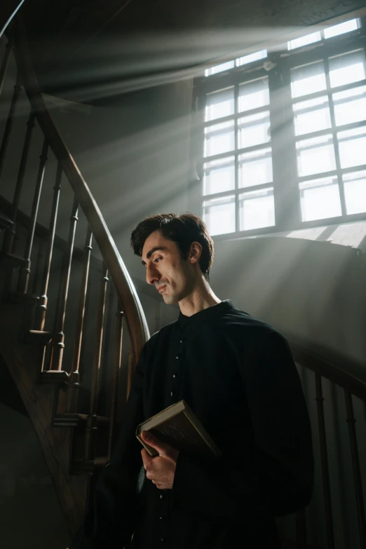 a man is standing by the railing in the dark