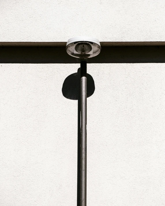 a po of some metal pole against a white wall