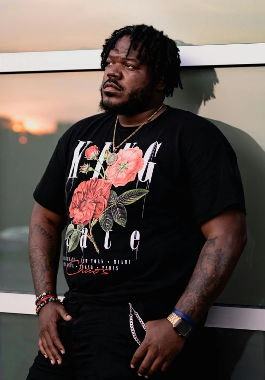 a close up of a person with a tie and a flower t - shirt