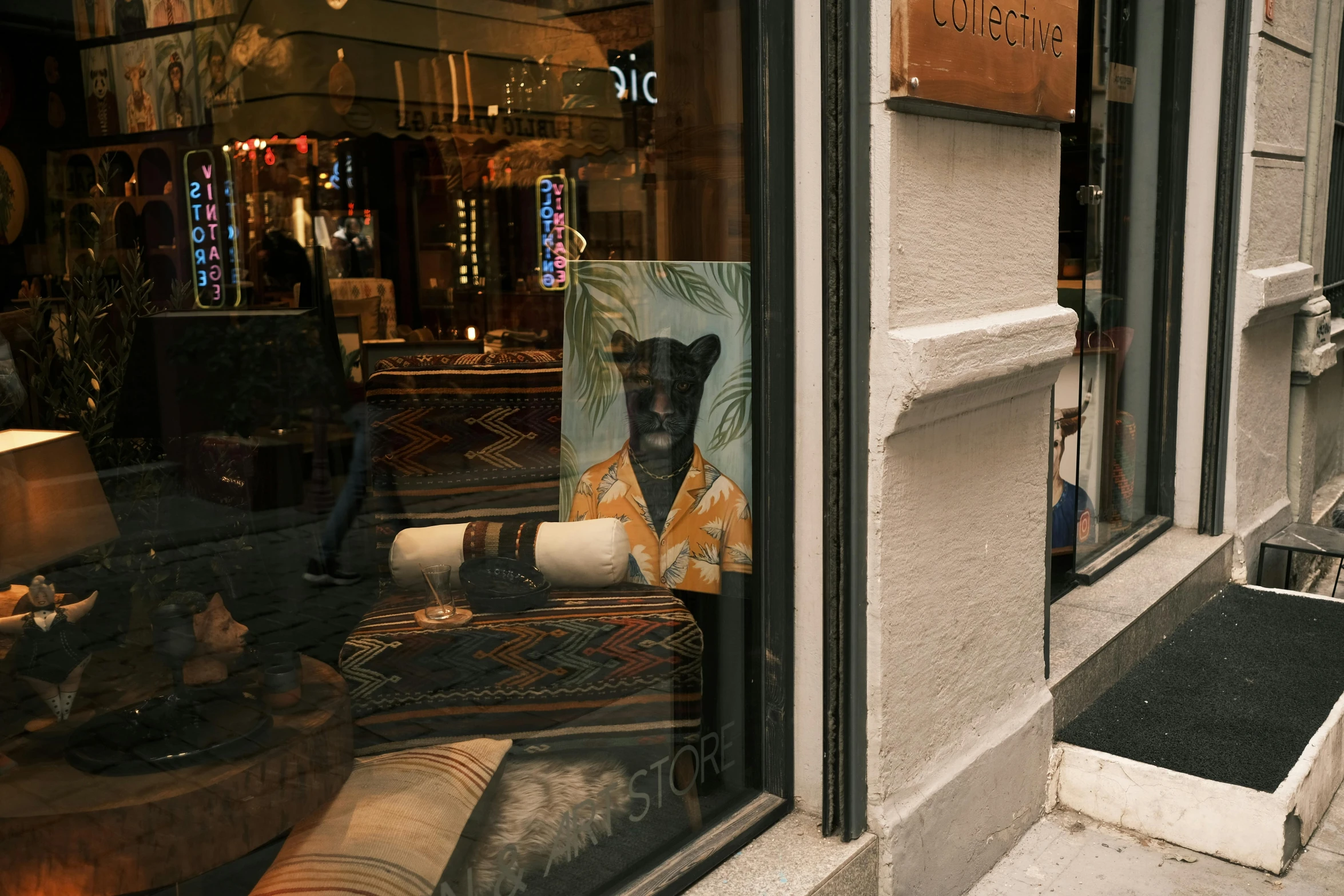 a store window with the front entrance open and its reflection of a bear in it's glass