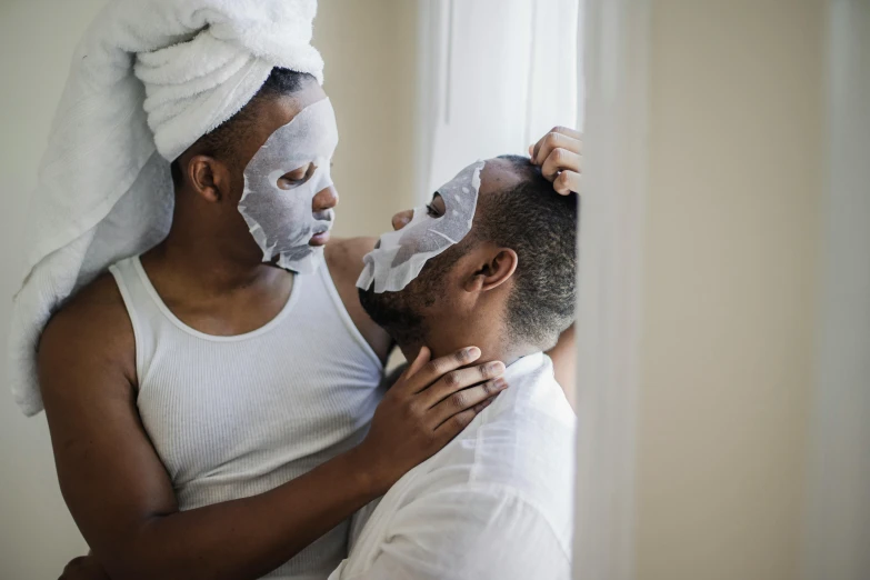 the man and woman are wearing masks while being dry