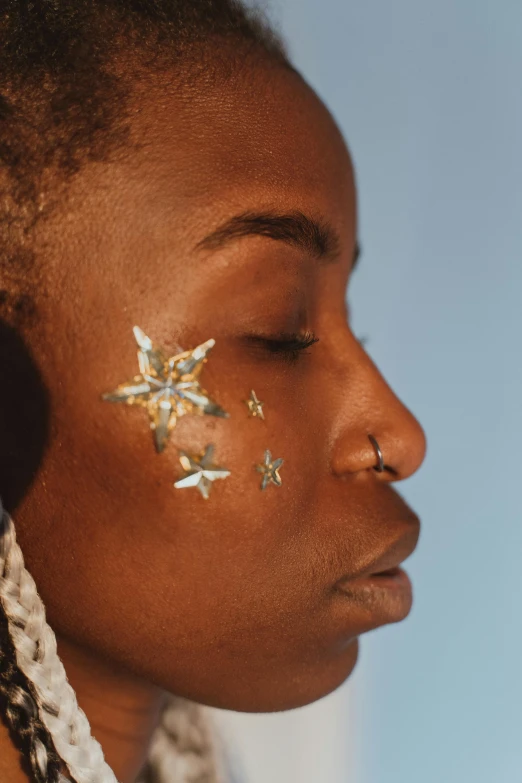 a woman with two silver stars on her face