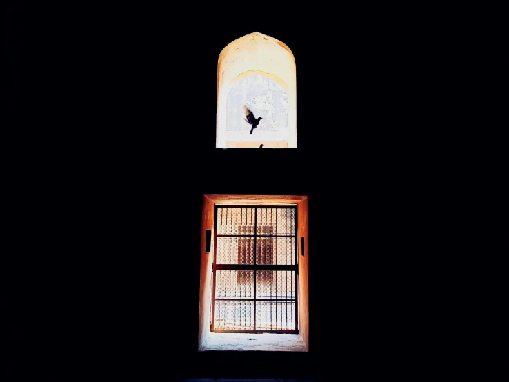 a window on a building at night looking outside