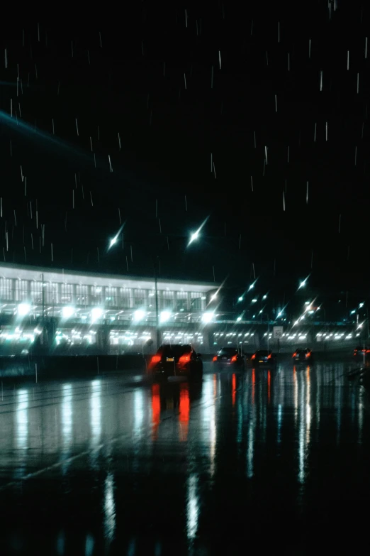 a rainy night and some cars in the street