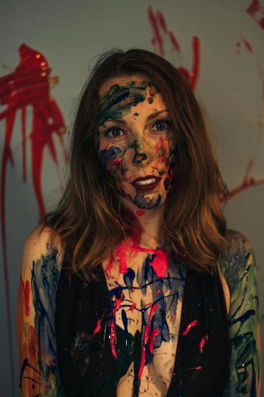a young woman with art paint all over her face