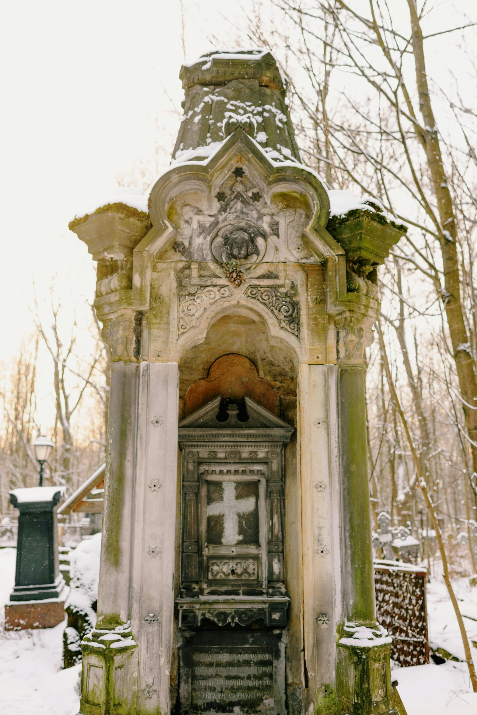 a stone structure is covered with a green moss