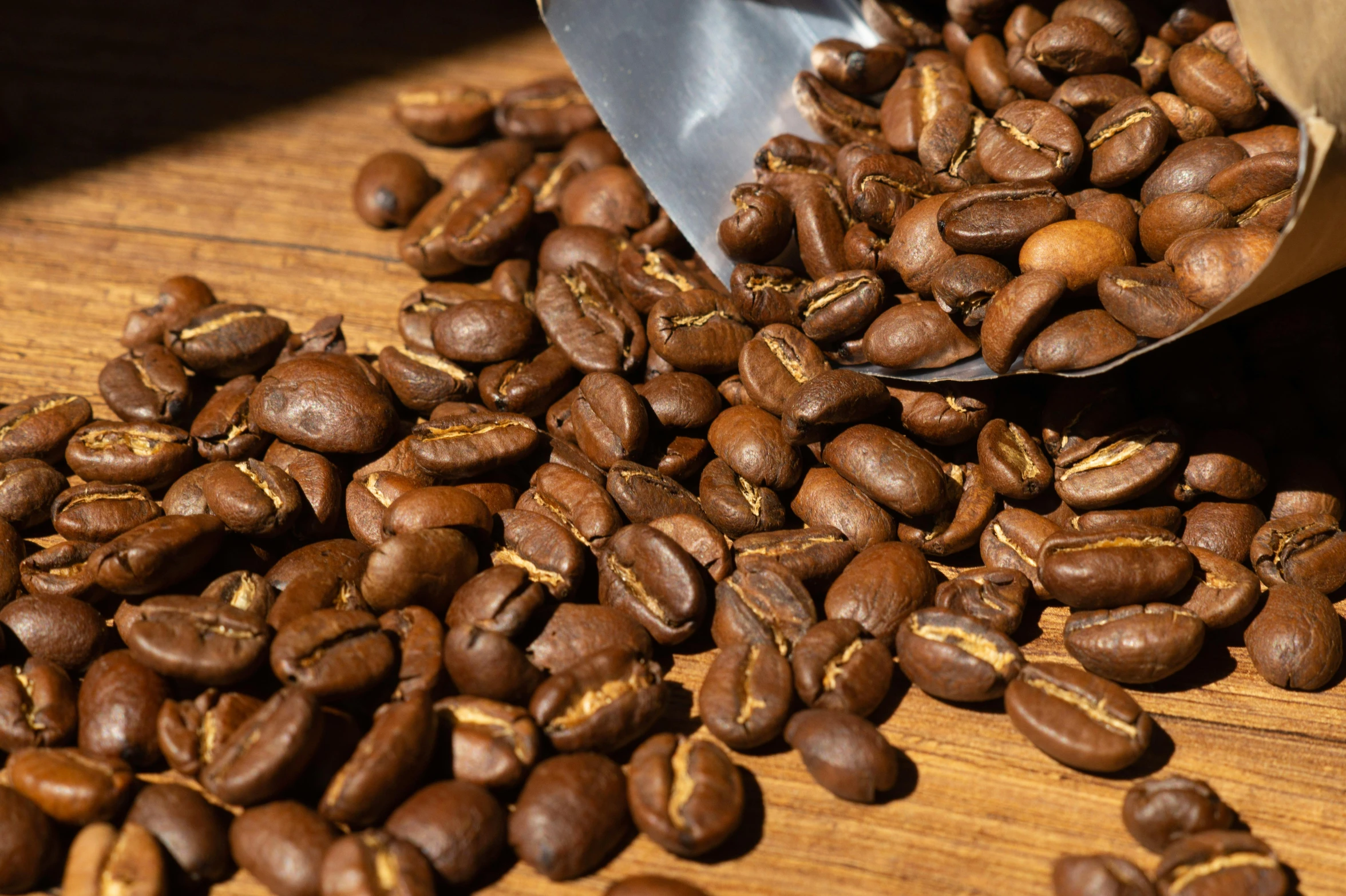 there are some coffee beans on the table and a kitchen knife