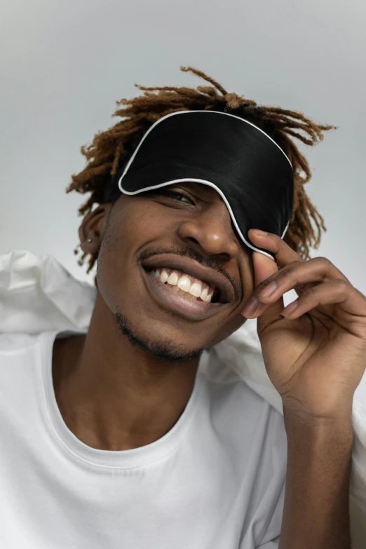 a man with dread locks smiling at the camera