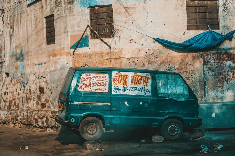 a van parked next to an old building with graffiti