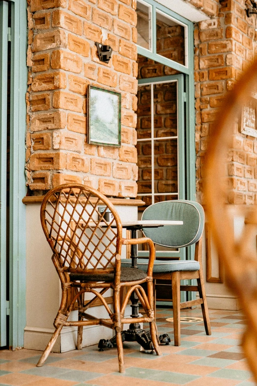 two chairs and a table outside of an outside cafe