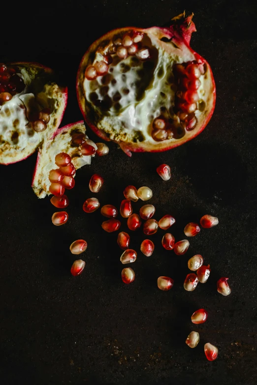 some ripe fruits have a couple bits cut out on a dark surface