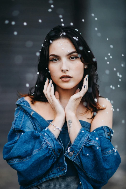 the woman is dressed in denim with an open shirt