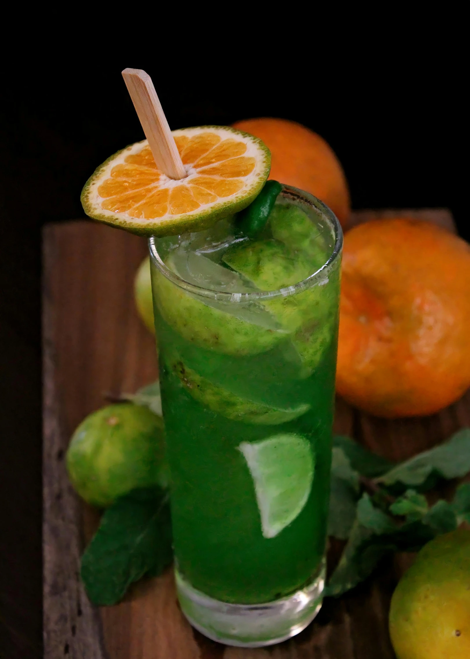 a green drink with a single orange on the rim