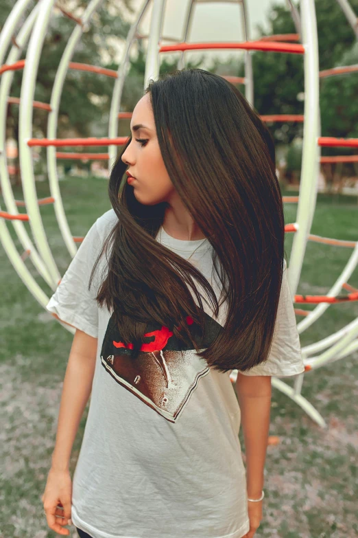 the woman is standing in front of a circular thing