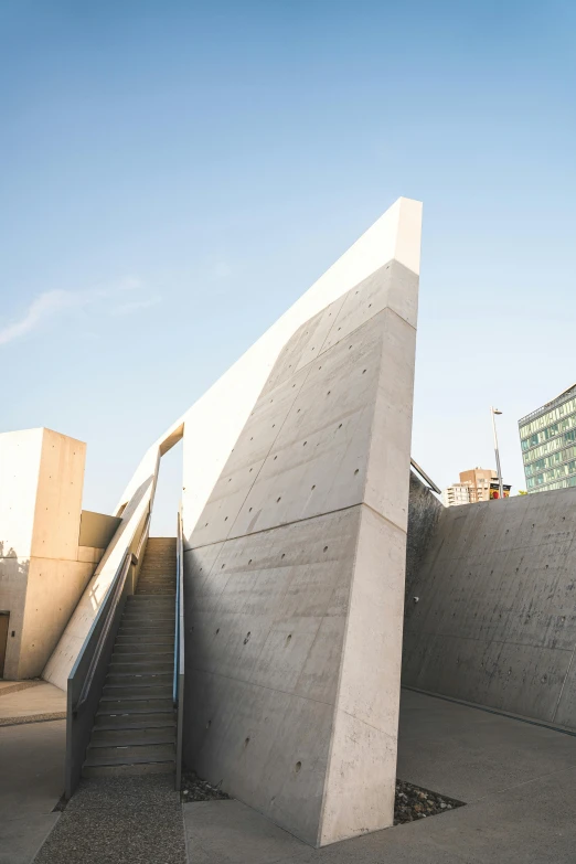 a building that has steps leading to it and an umbrella in the corner of it