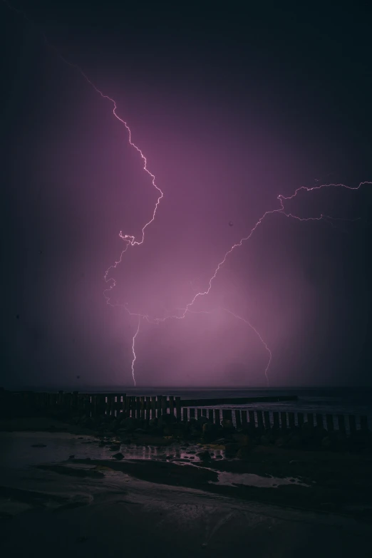 a lightning strike is seen above the ocean