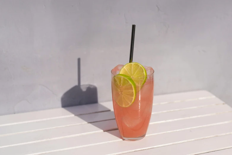 an orange beverage with some lime wedges next to it