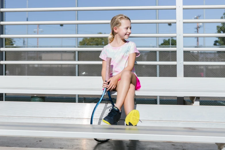 a little girl that has a racket in her hand