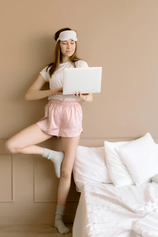 a girl with a laptop leaning on her head